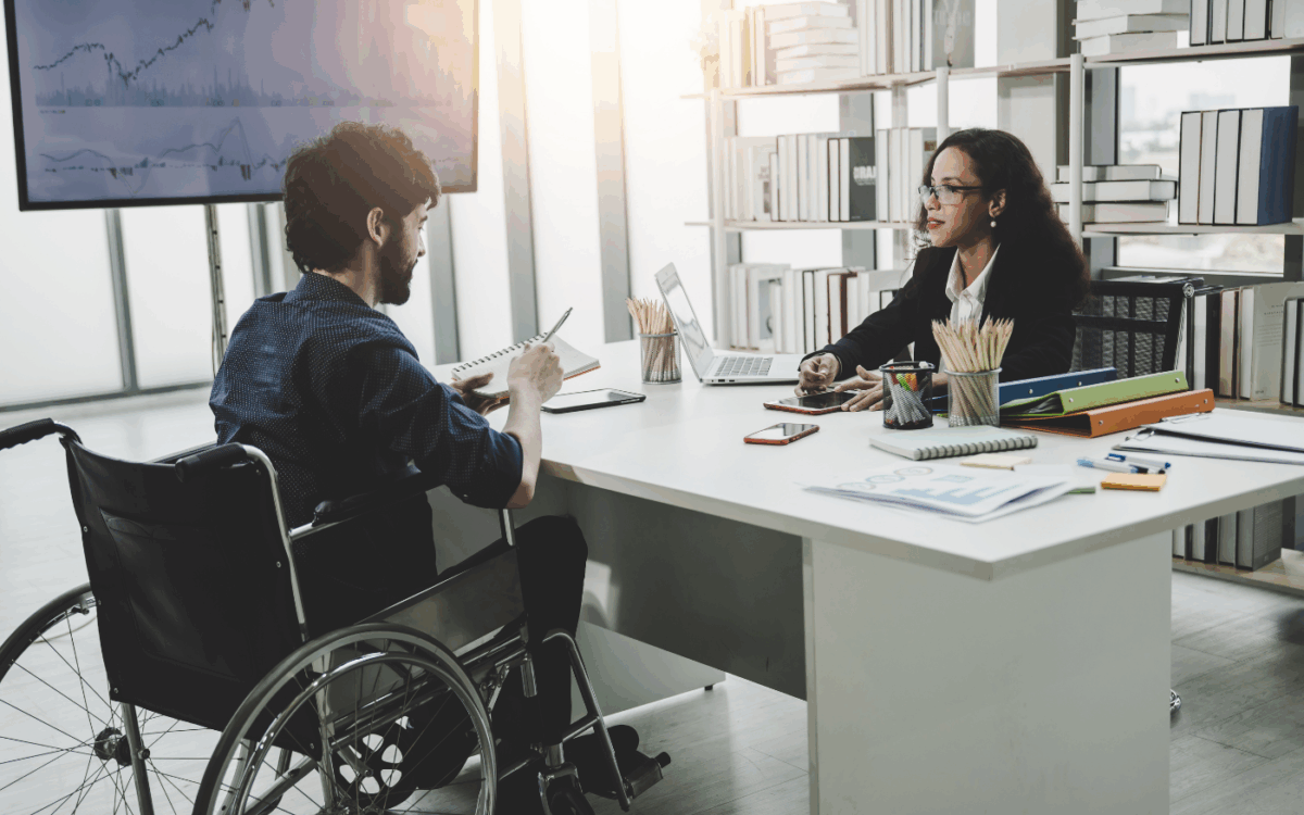 Man in wheelchair in a government meeting