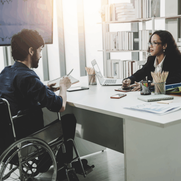 Man in wheelchair in a government meeting