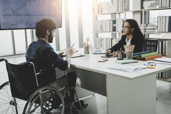 Man in wheelchair in a government meeting